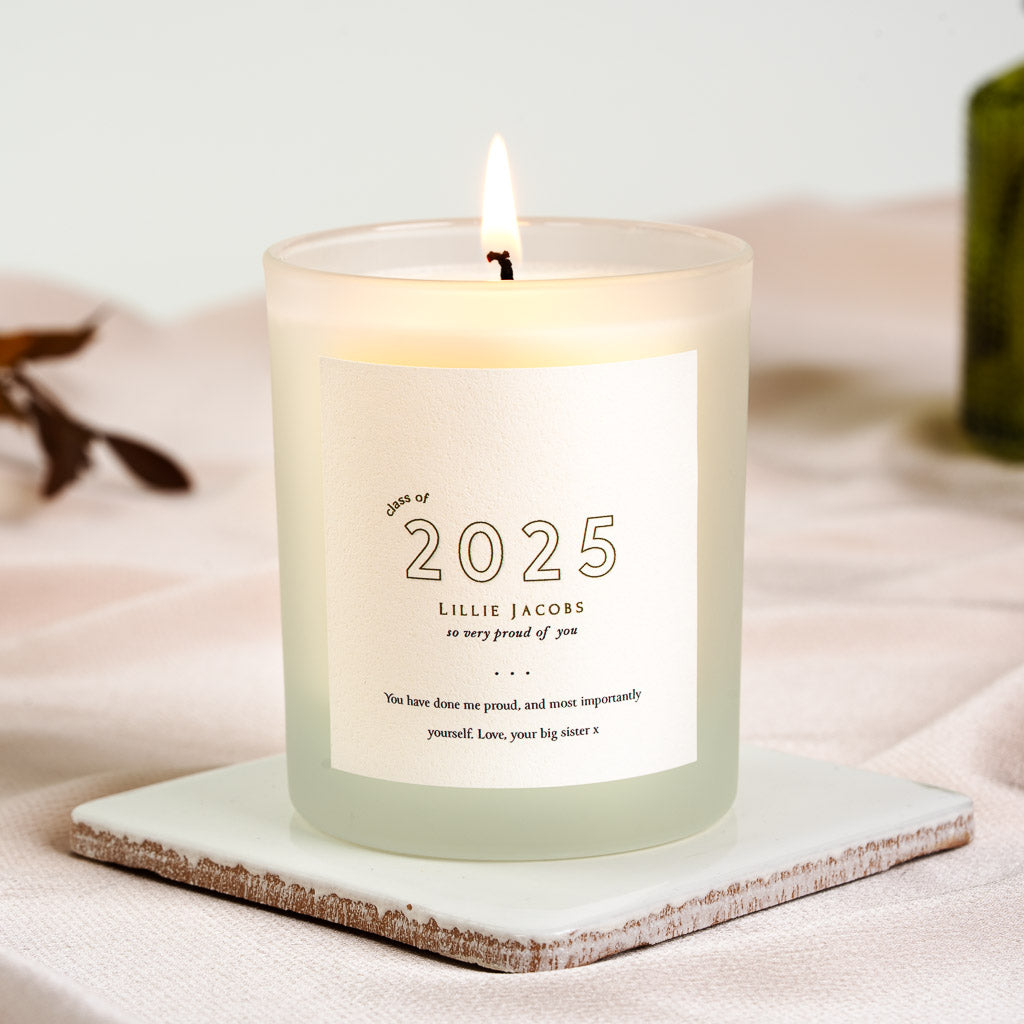 Graduating year in large outlined numerals above the name on a personalised graduation candle