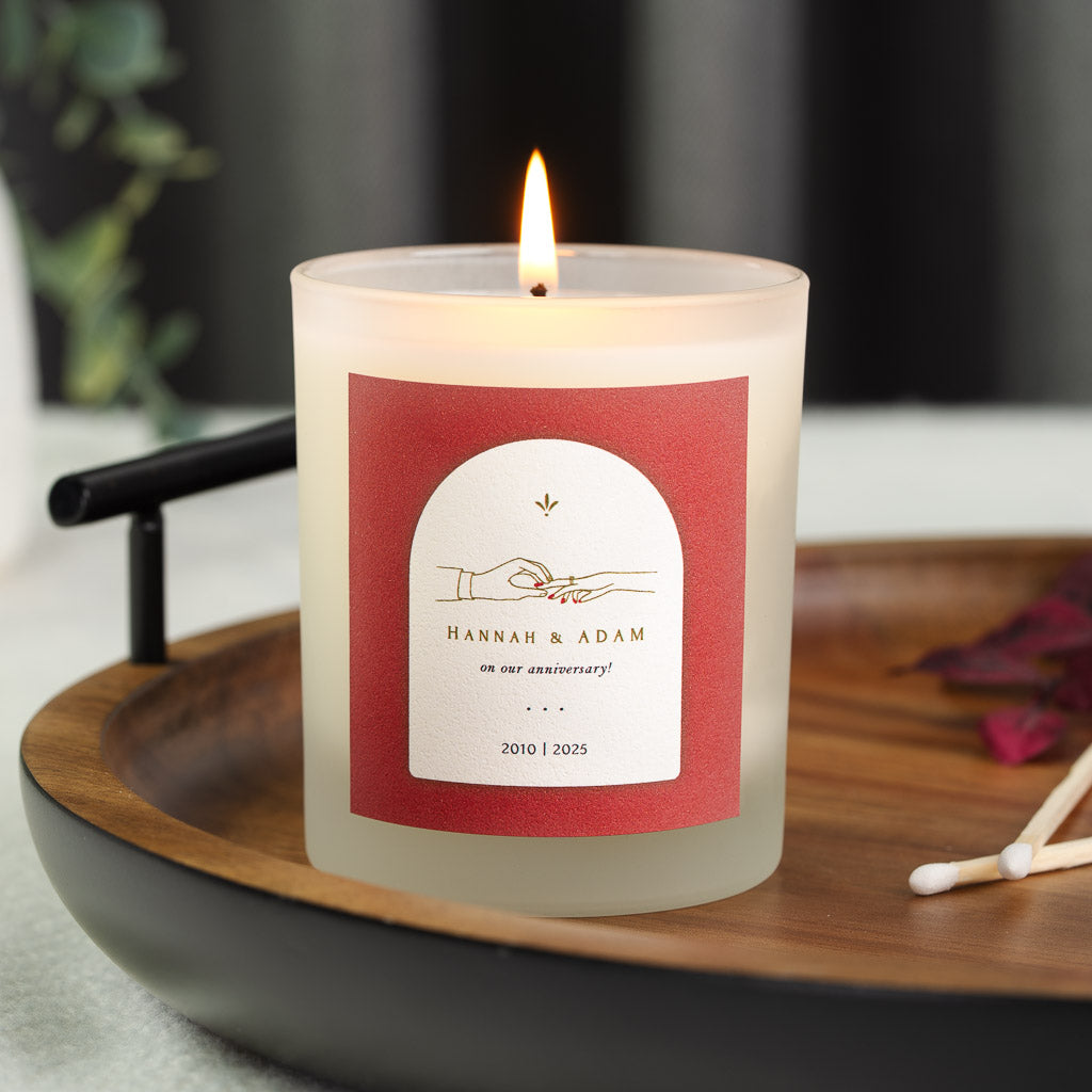 Personalised anniversary candle with a floral arch framing the couple's names