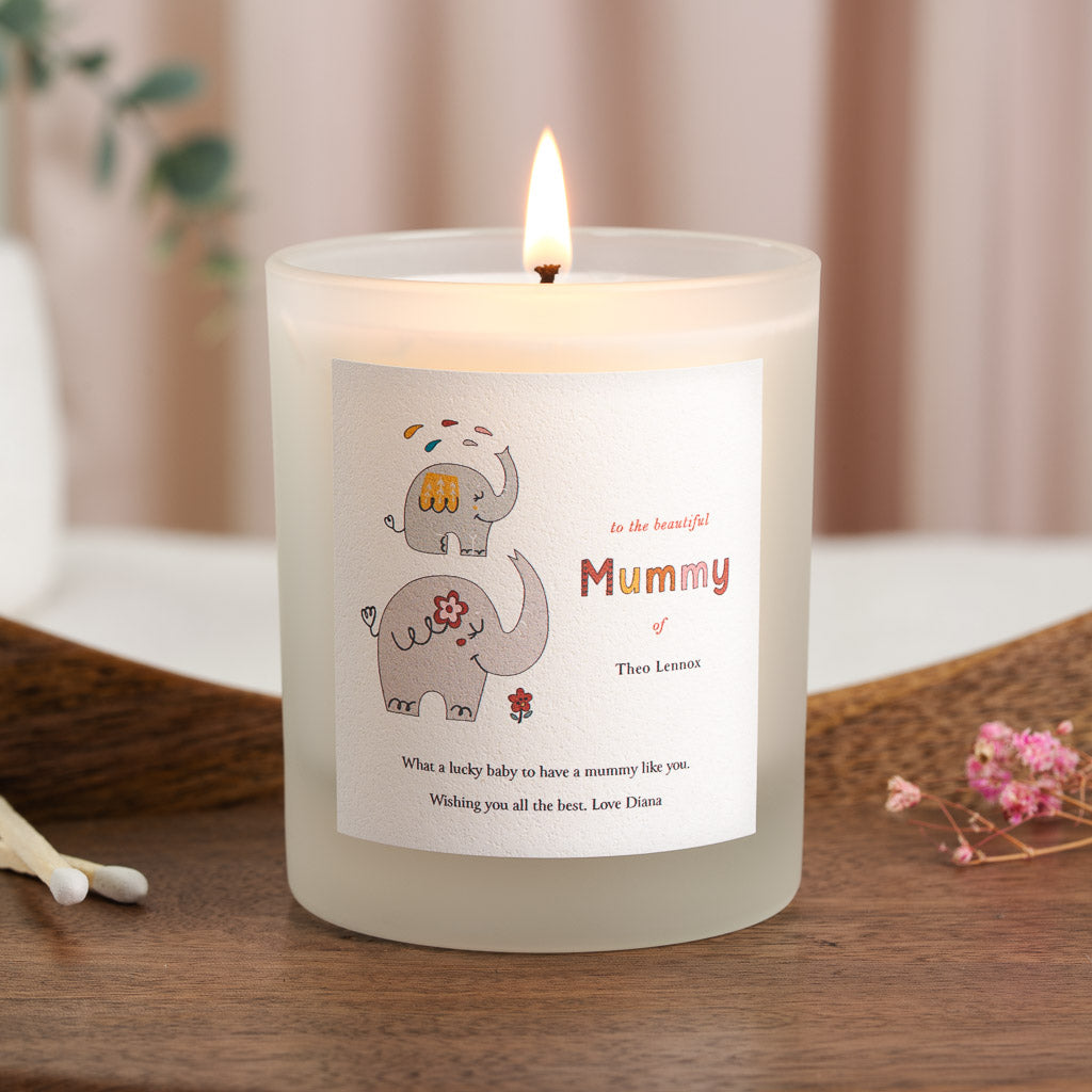 Two hand-drawn elephants beside the chosen relationship on a personalised new baby candle