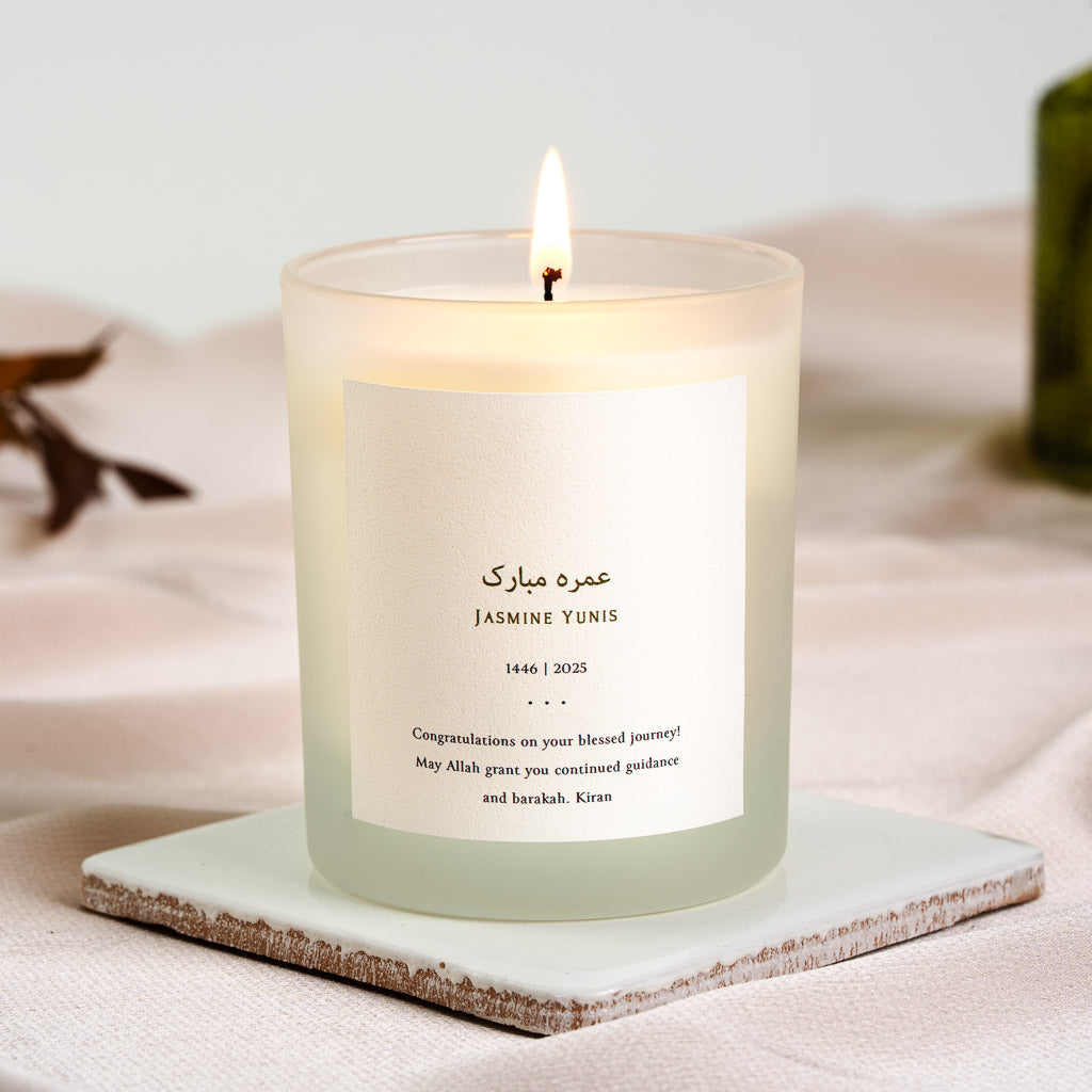 Personalised Umrah mubarak candle with gold-toned Arabic script above the name