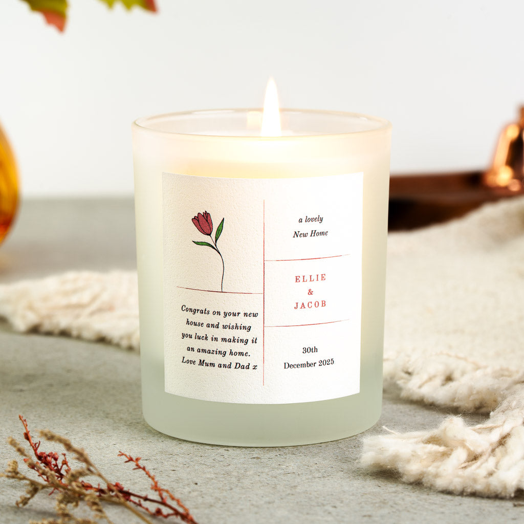 Two-column layout with a flower beside the names on a personalised housewarming candle