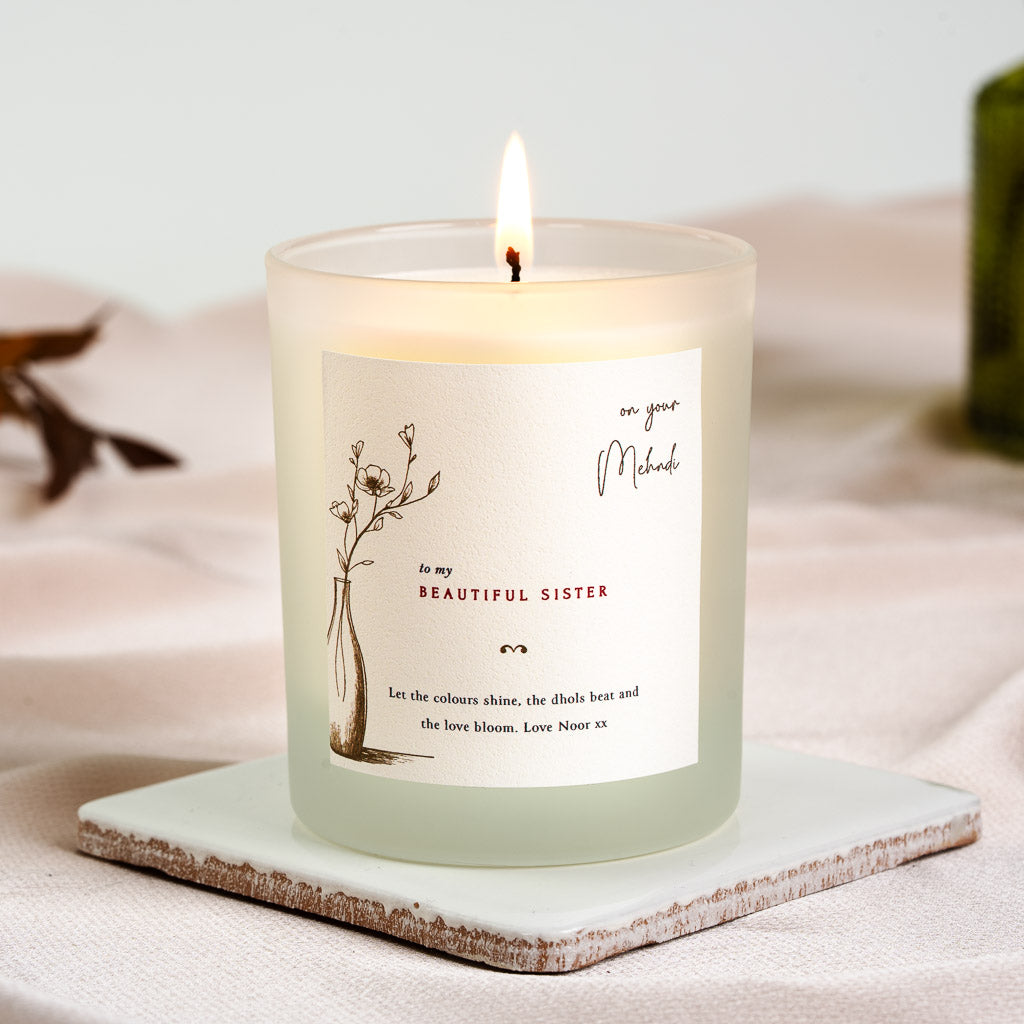 Personalised mehndi candle with a line-drawn stem of flowers in a vase to one side