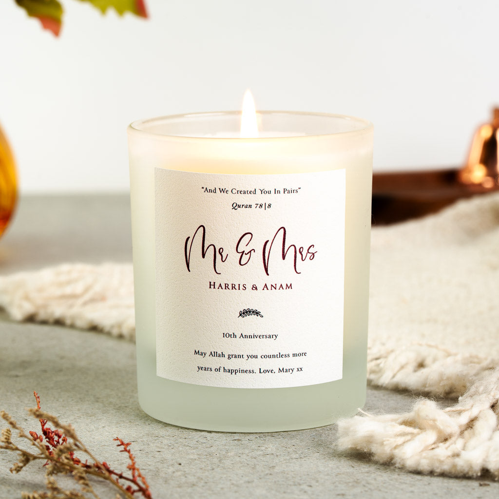 Quran verse above Mr and Mrs in maroon script on a personalised anniversary candle label