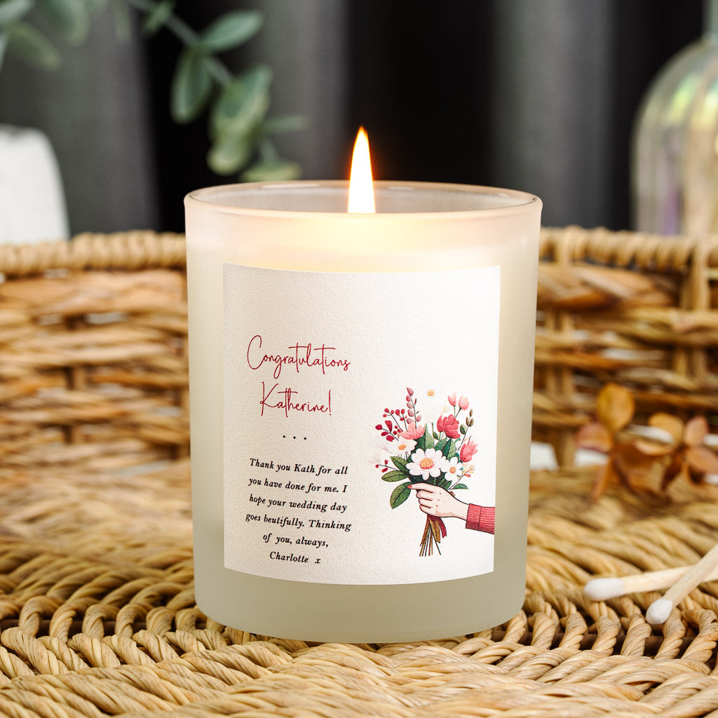 Bouquet illustration beside red script congratulations on a personalised wedding candle