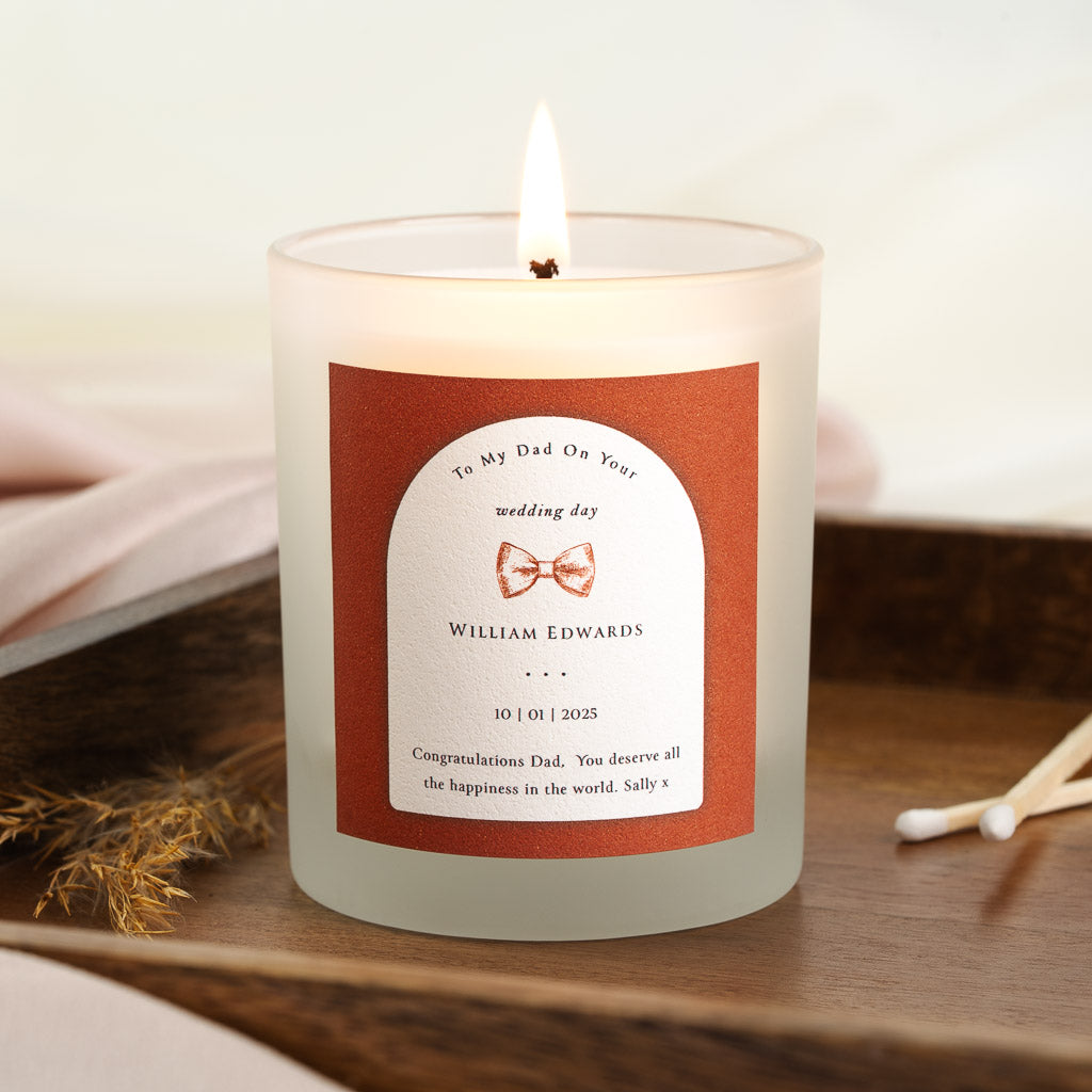 Personalised wedding candle with a bow tie illustration above the name and date