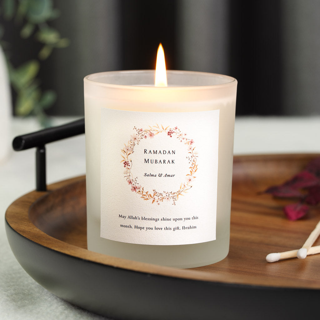 Ring of painted flowers and foliage framing the greeting on a personalised Ramadan candle