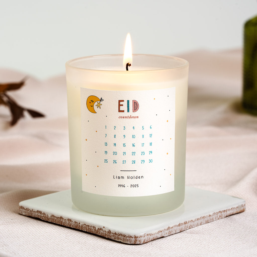 Smiling crescent moon and star beside mixed lettering on a personalised Eid countdown candle