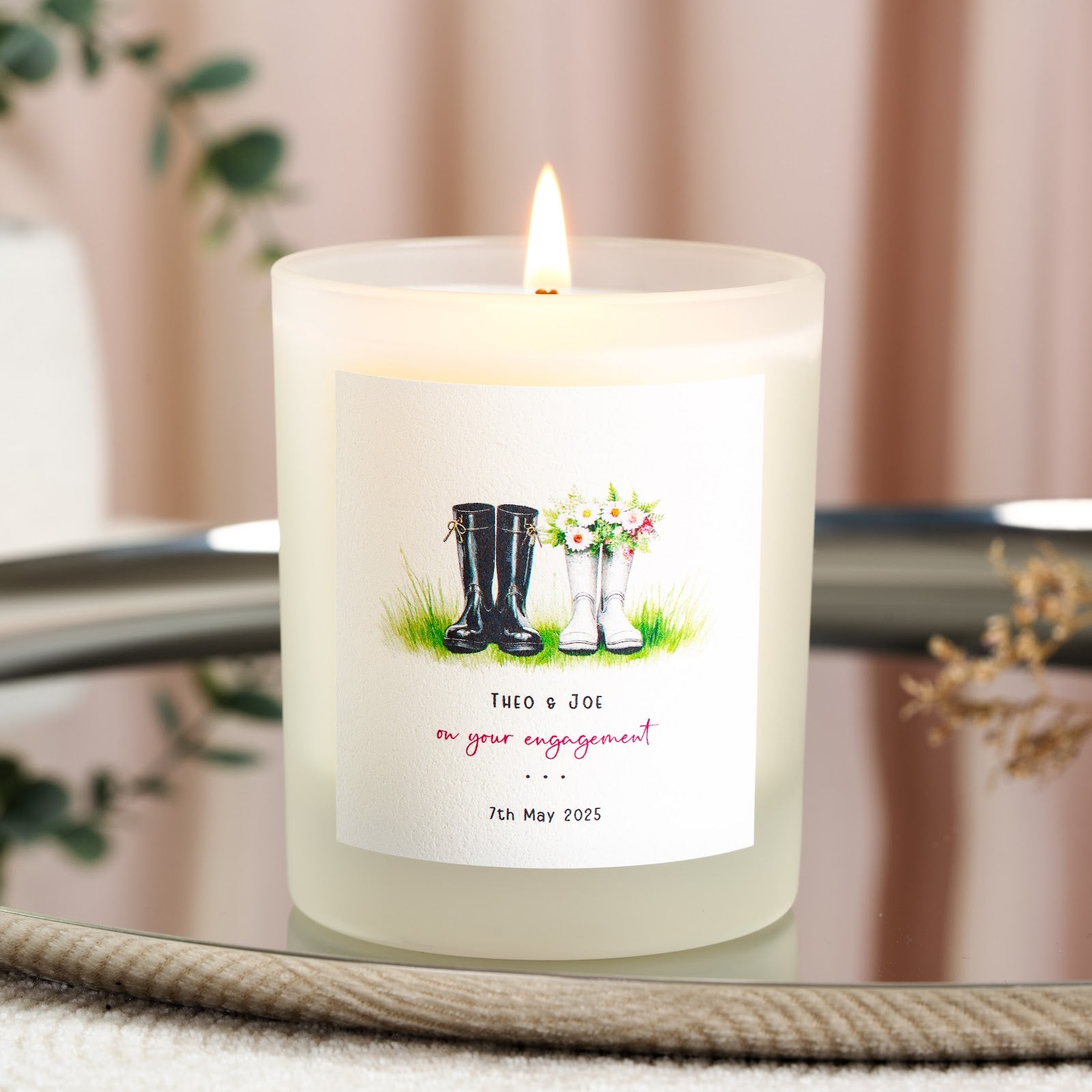 Personalised engagement candle with his and hers wellies above pink script lettering