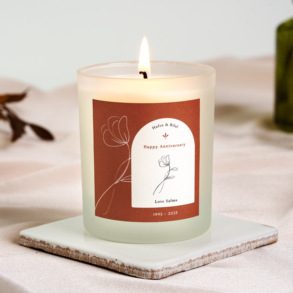 Personalised anniversary candle with a small flower inside an arched panel