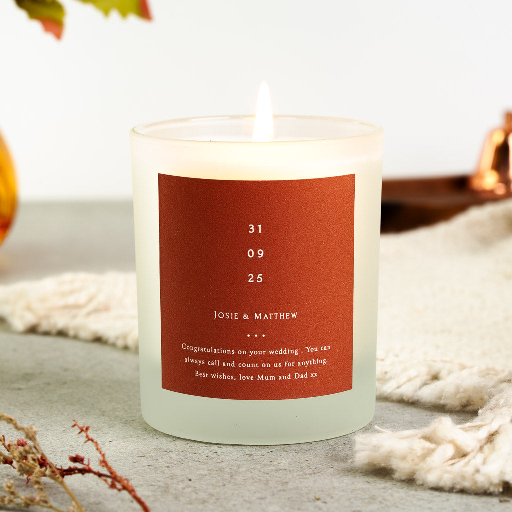 Personalised wedding candle with the wedding date stacked in large white numerals on rust