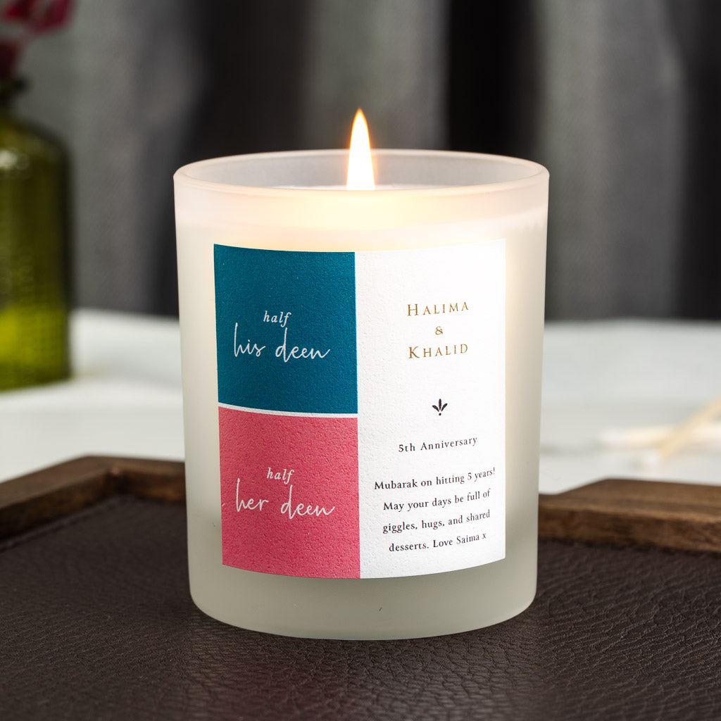 Personalised anniversary candle with deep teal and coral panels set side by side