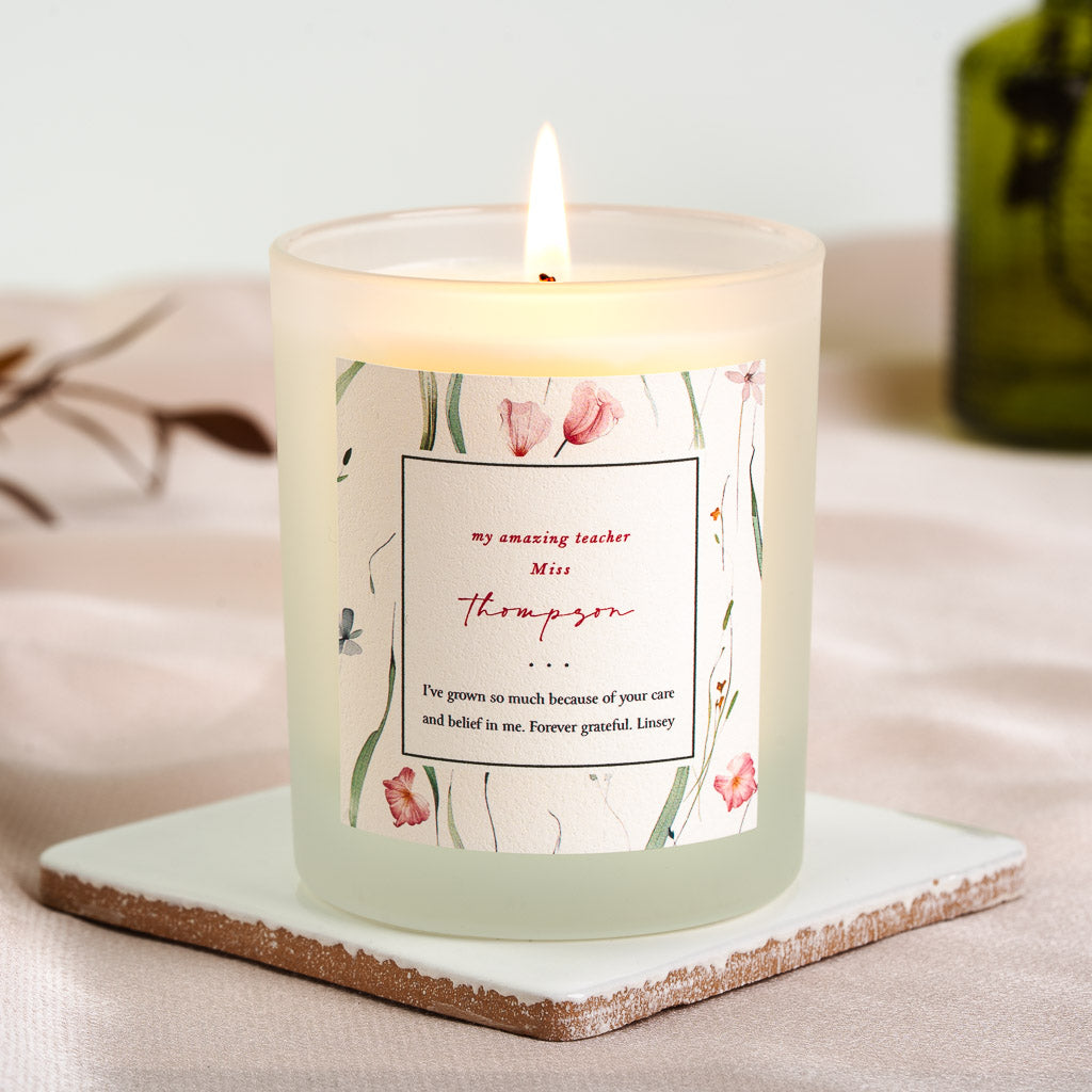 Personalised teacher candle with blue, pink and yellow wildflowers bordering an outlined box