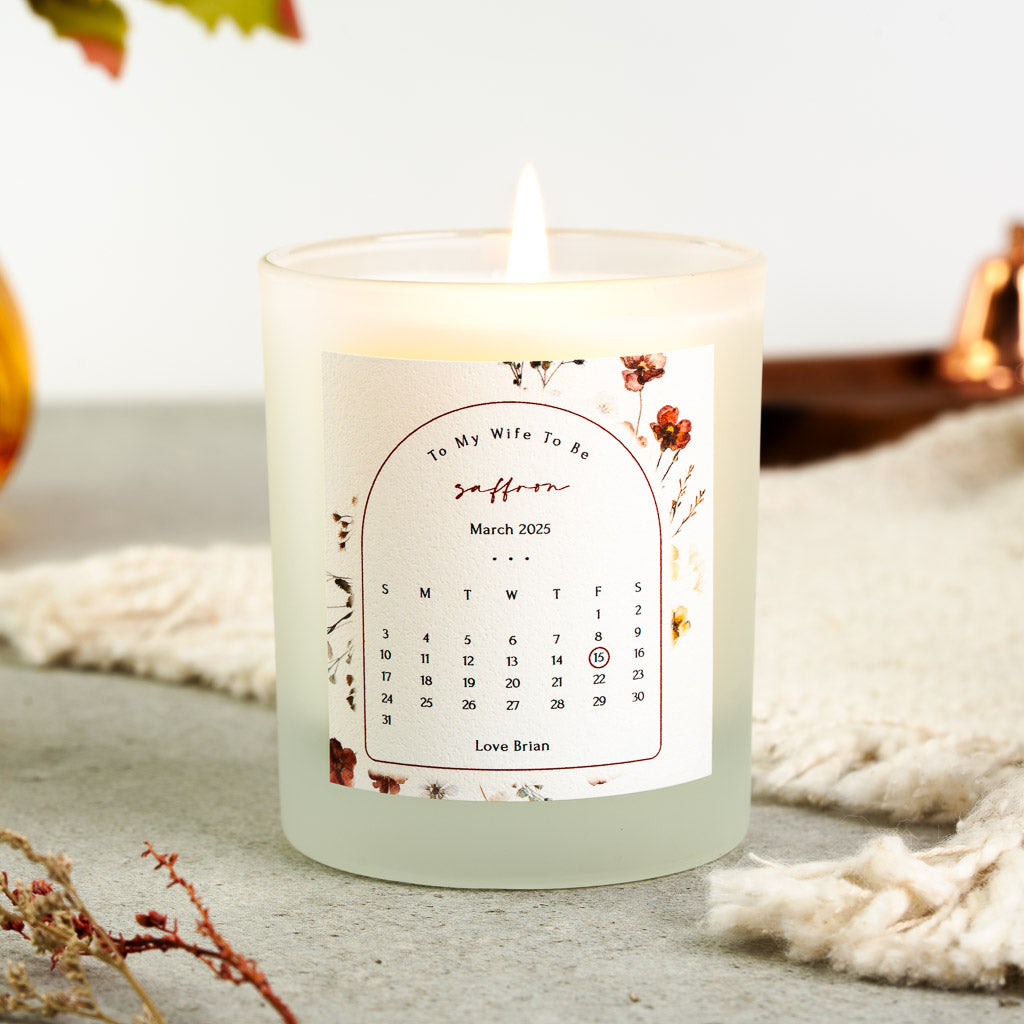 Personalised wedding candle with a month calendar circled in red inside an autumnal floral arch