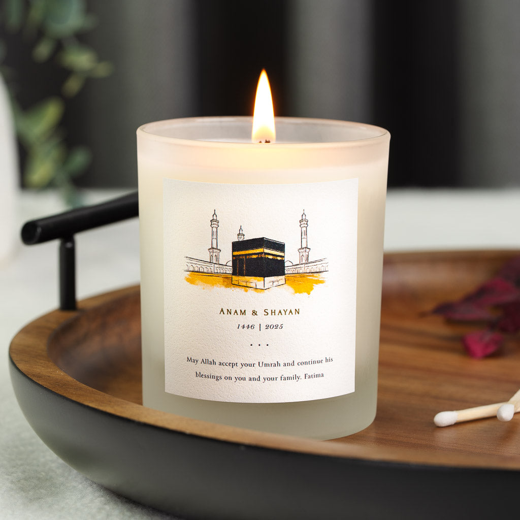 Personalised Umrah candle with the Kaaba painted in black, gold and white on a sand wash