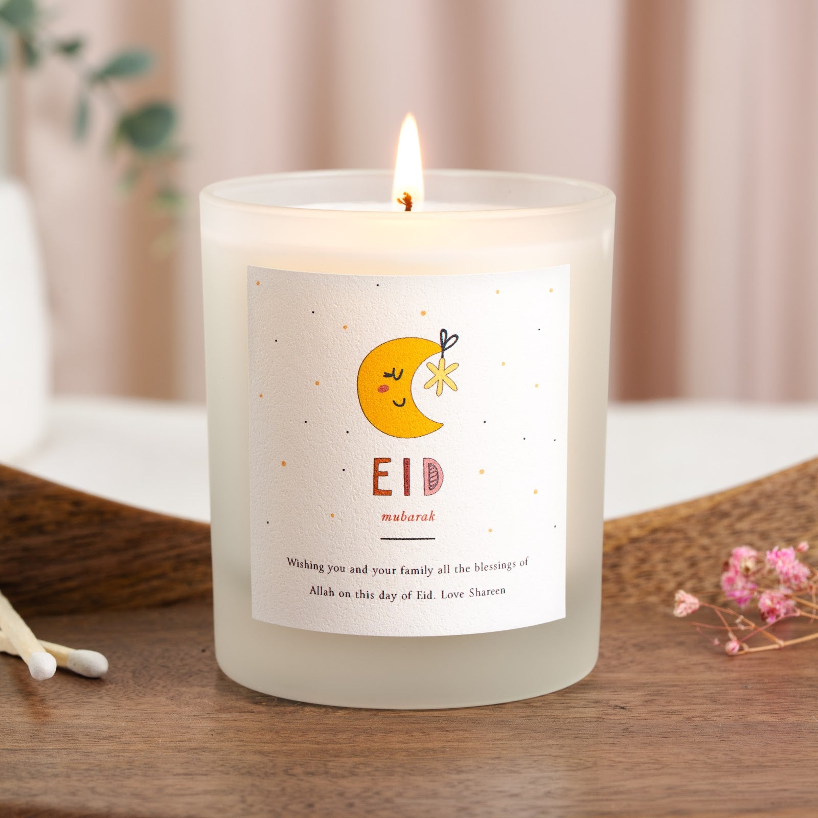 Personalised Eid candle with a smiling crescent moon and a small hanging star