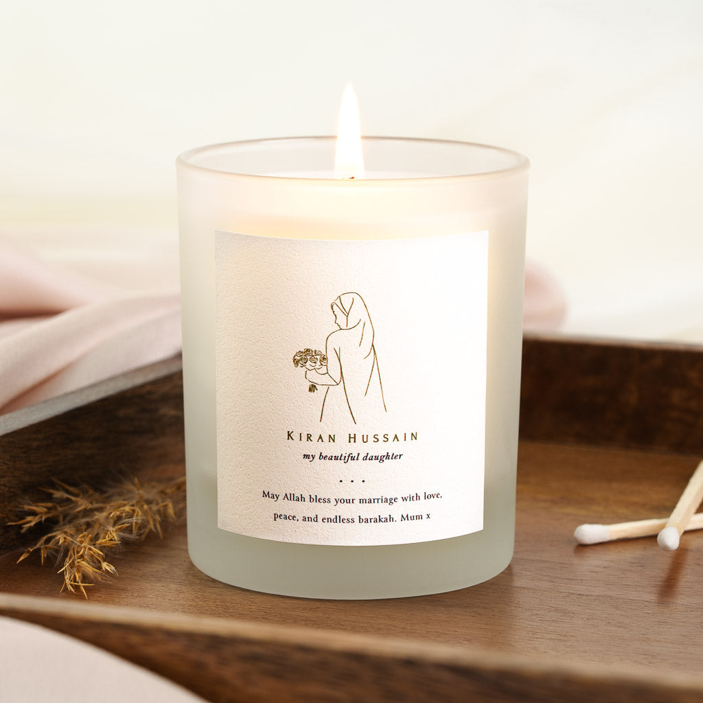 Personalised nikah candle with a gold line figure carrying a bouquet above the name