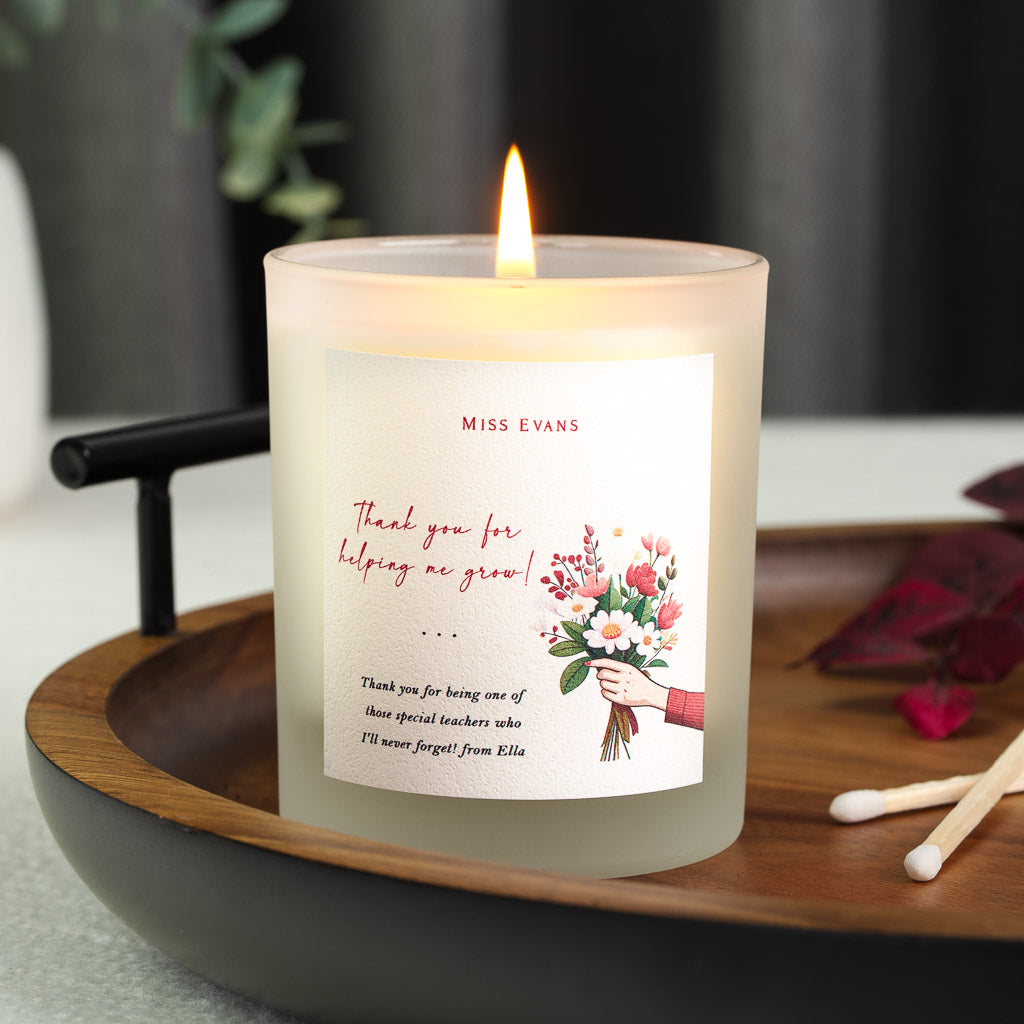 Personalised teacher candle with a hand-drawn arm holding a pink and white bouquet