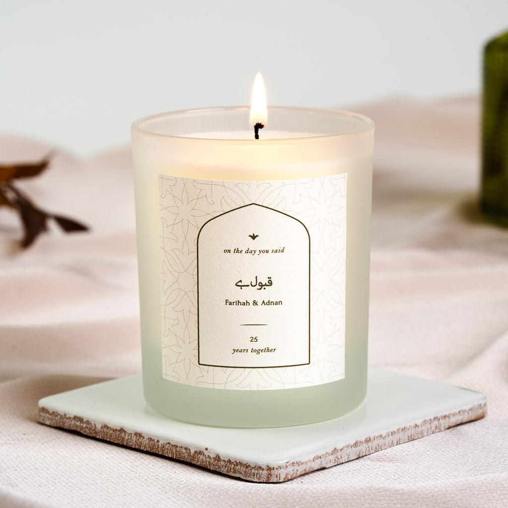 Warm gold arched panel on a fine floral geometric pattern on a personalised anniversary candle
