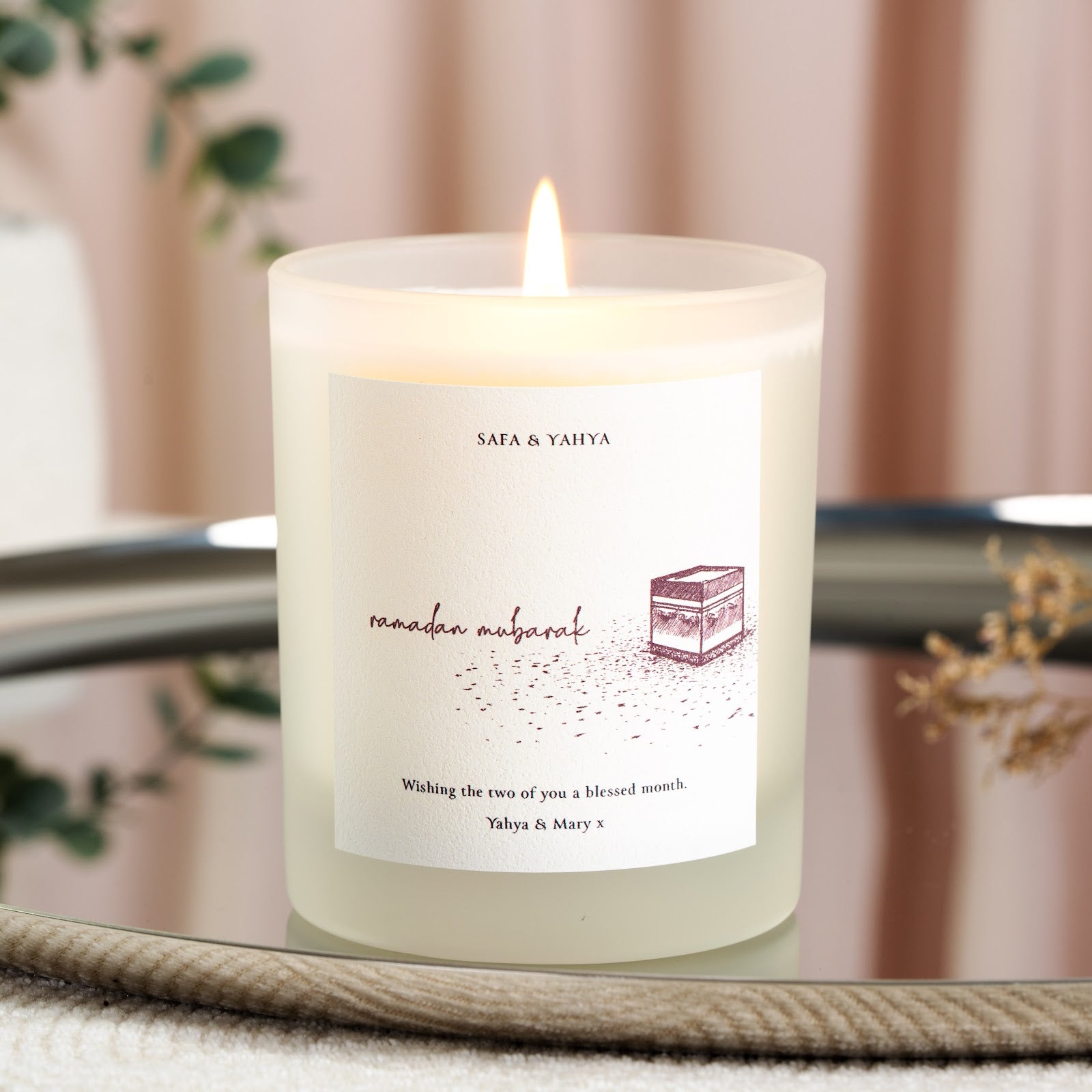 Hand-sketched Kaaba in maroon ink with a dot texture on a personalised Ramadan candle