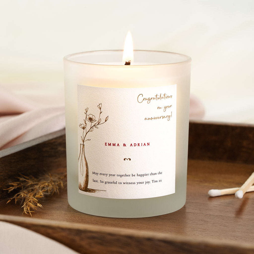 Personalised anniversary candle with a sketched vase set opposite a script heading