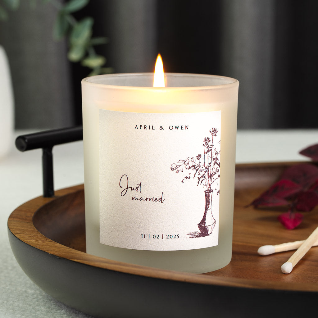 Personalised wedding candle with an ink-sketched vase of dried stems and just married in script