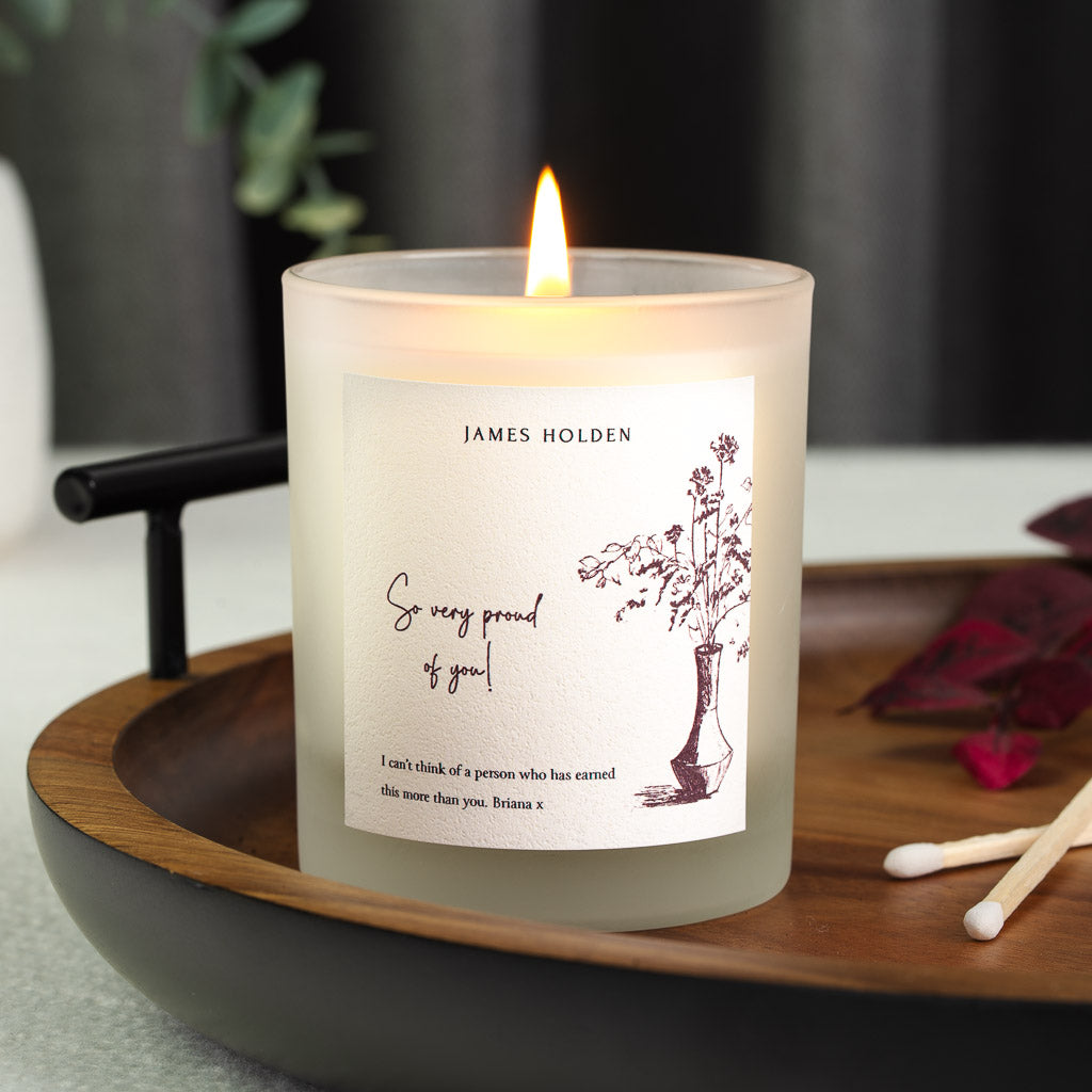 Wildflower illustration set beside a loose script message on a personalised candle label