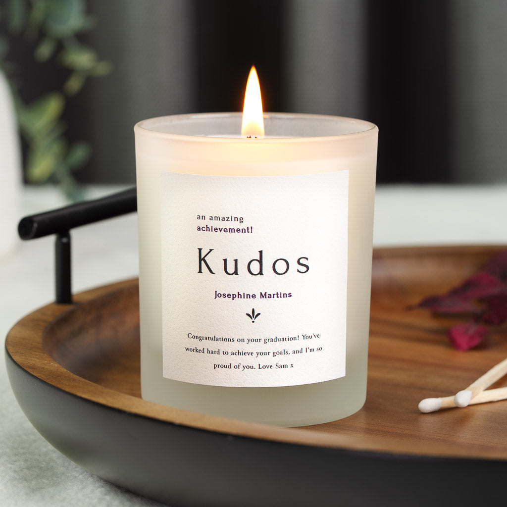 Personalised congratulations candle with an achievement line above bold kudos lettering