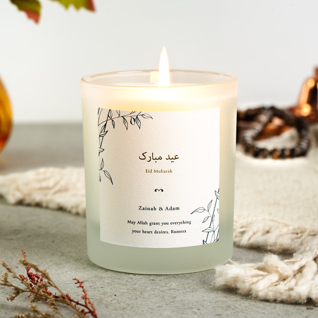 Personalised Eid candle with black line-drawn leaves in opposite corners