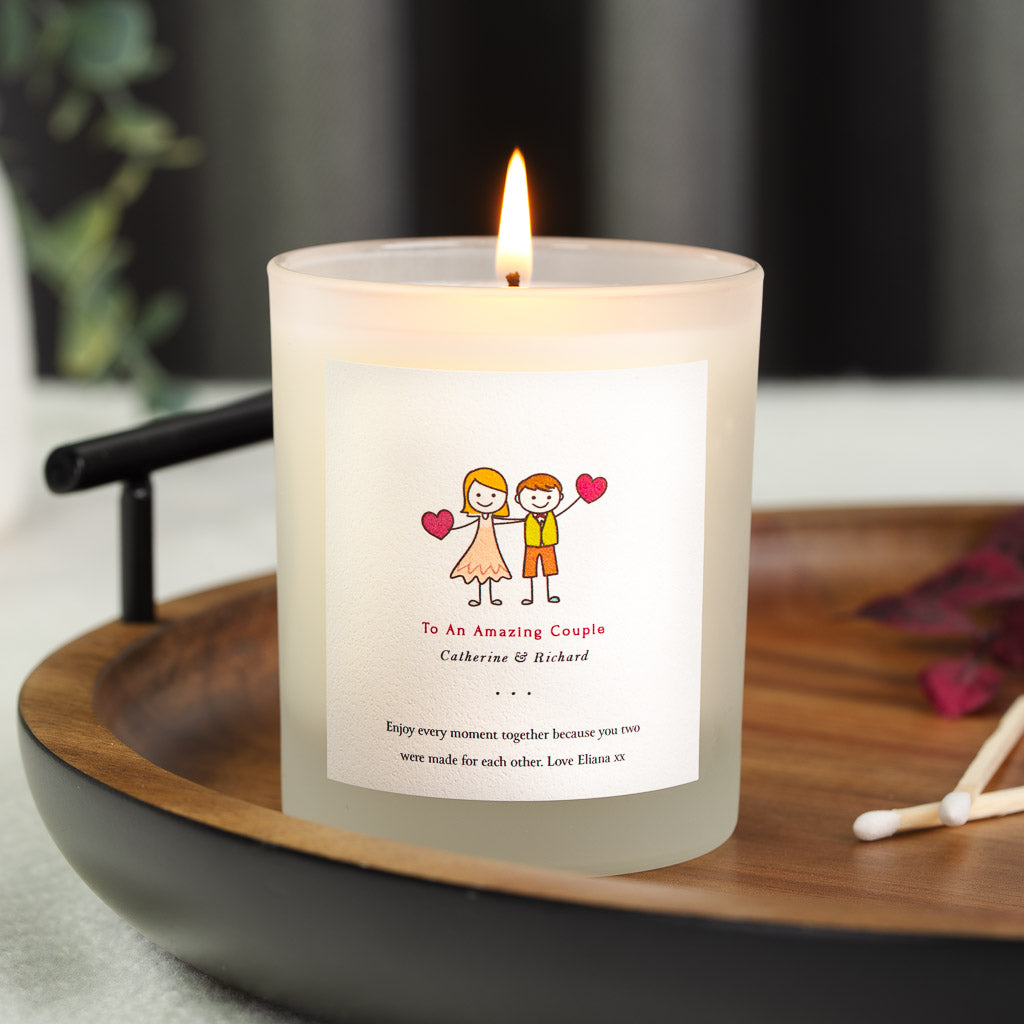 Personalised wedding candle with two hand-drawn figures holding red hearts