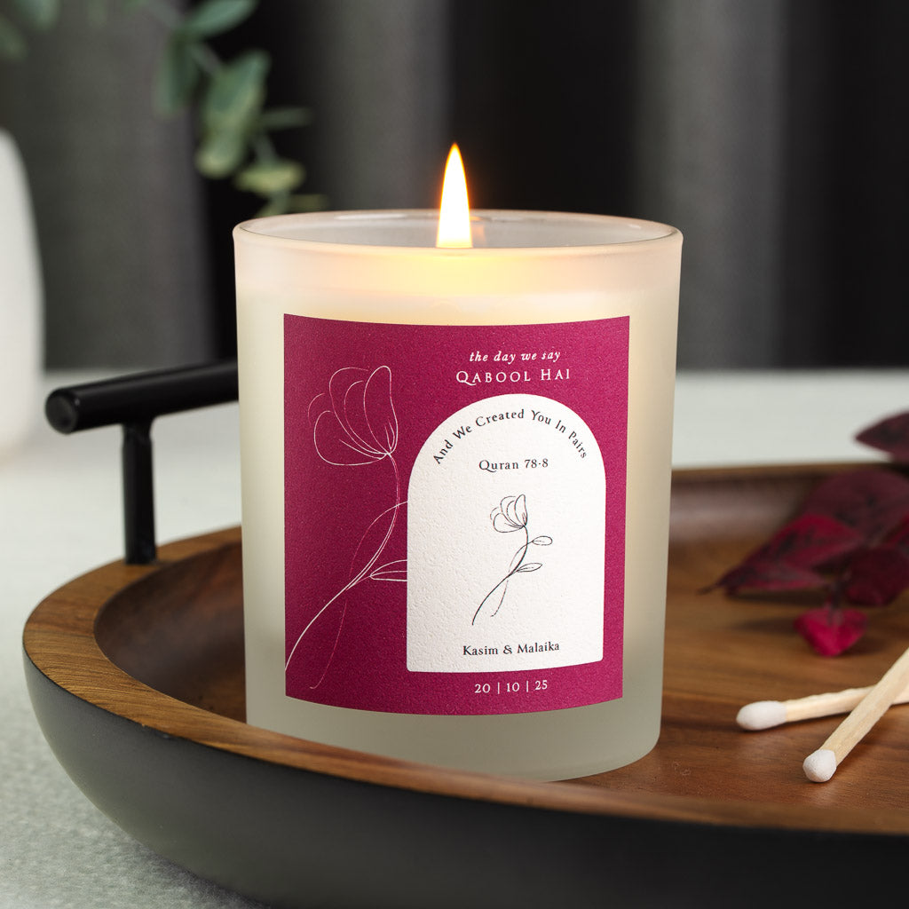 Line-drawn flower beside an arched panel bearing Surah An-Naba on a personalised nikah candle