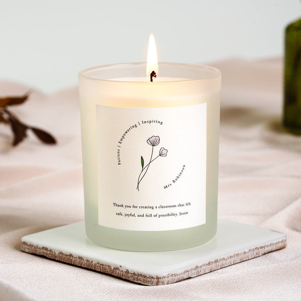 Personalised teacher candle with a line-drawn flower framed by three describing words