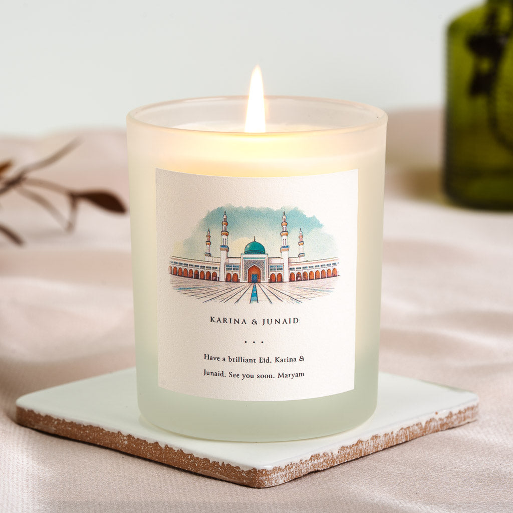 Watercolour mosque with a deep teal dome on a pale blue personalised Eid candle label