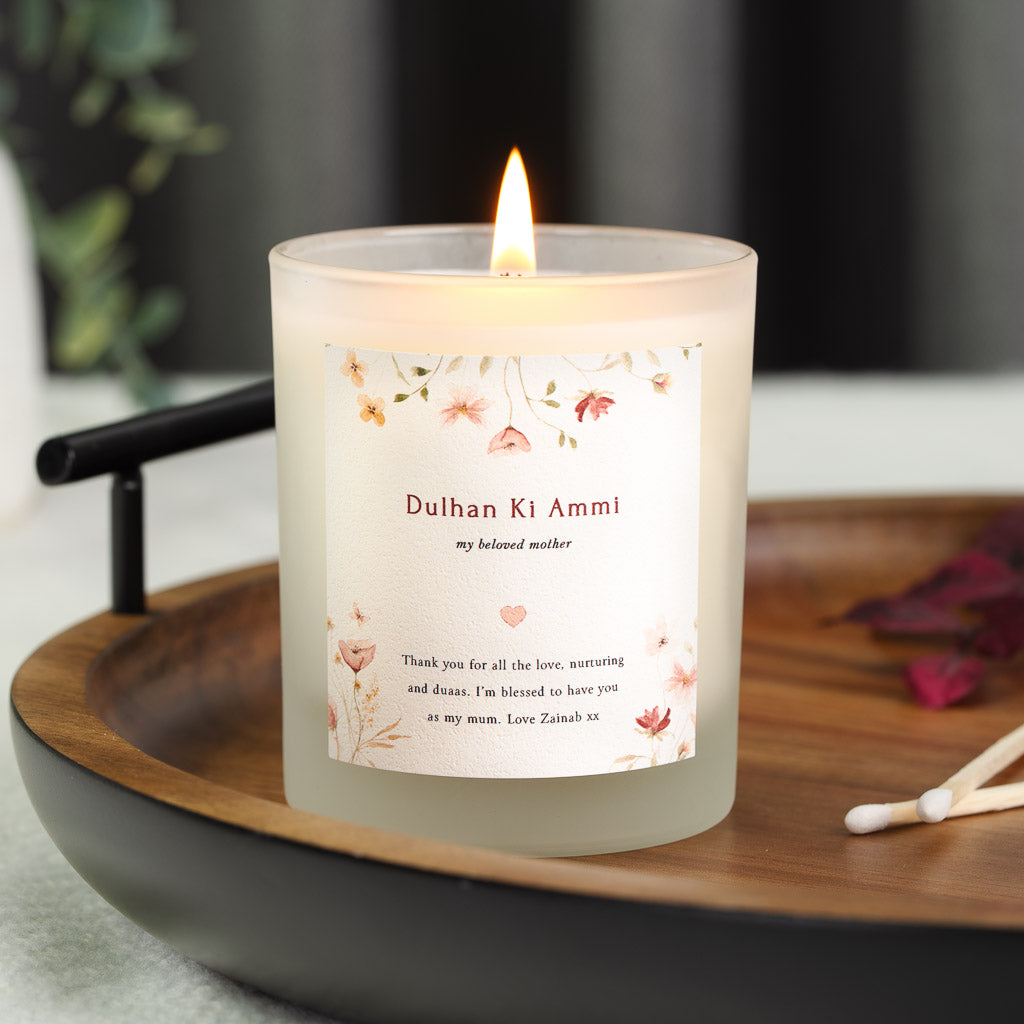Pressed wildflowers above a Dulhan Ki Ammi heading on a personalised wedding candle label