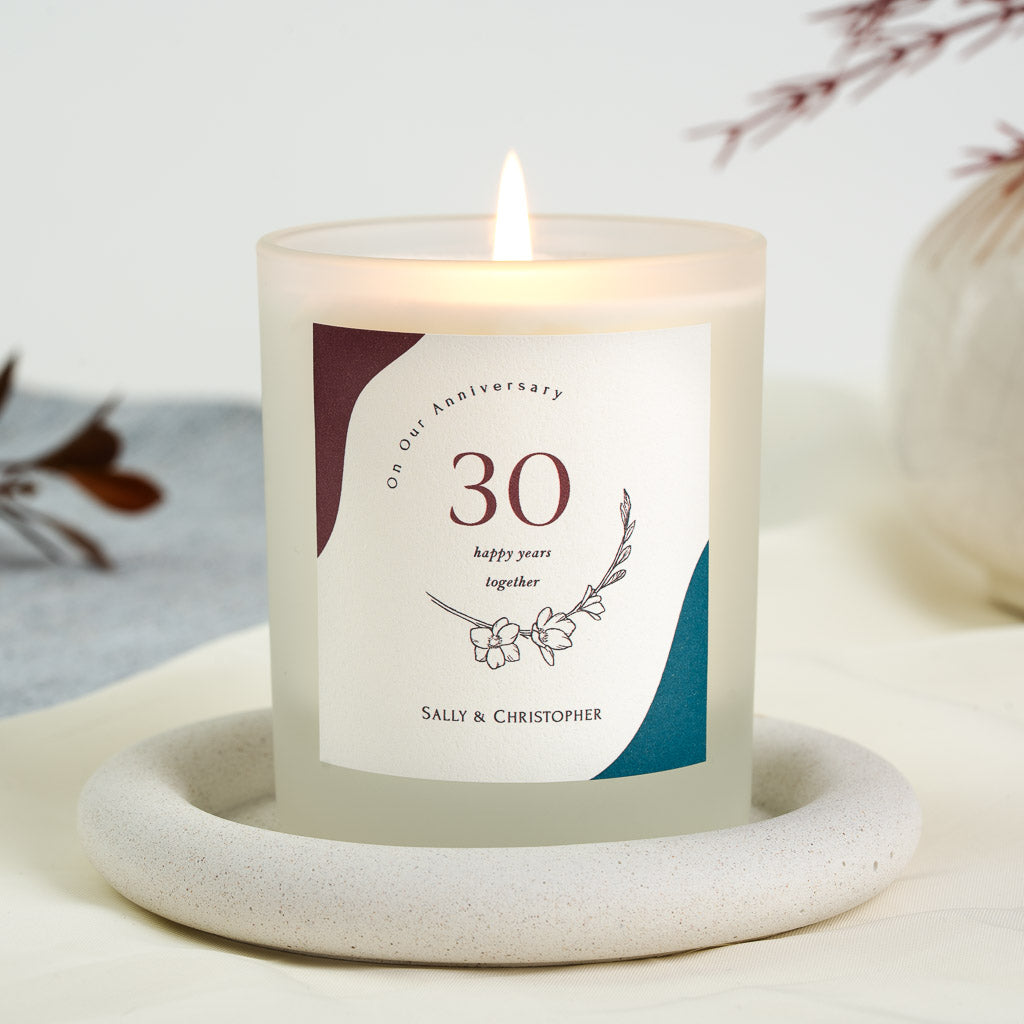 Years together centred above a flower illustration on a personalised anniversary candle