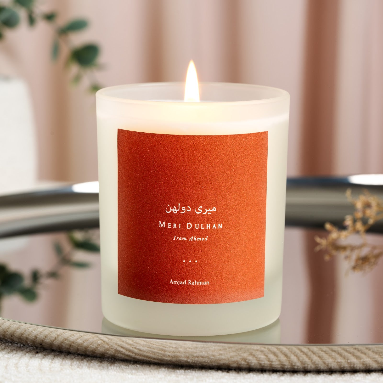 Personalised Meri Dulhan candle with white script on a solid warm orange label