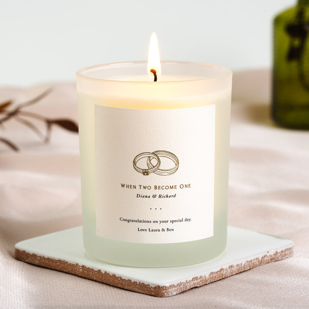 Two interlocking wedding rings in fine line art on a personalised wedding candle label