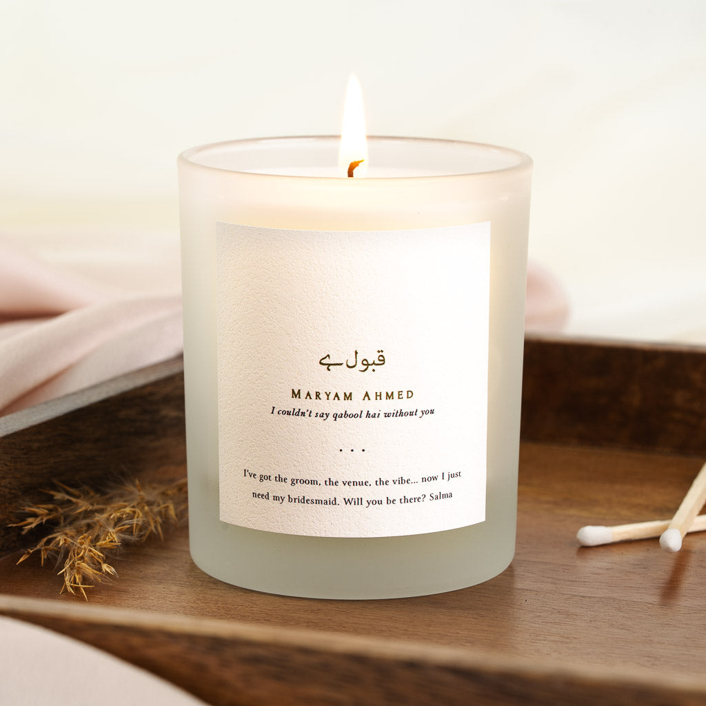 Personalised bridesmaid candle with brown Urdu script above a line about the qabool hai