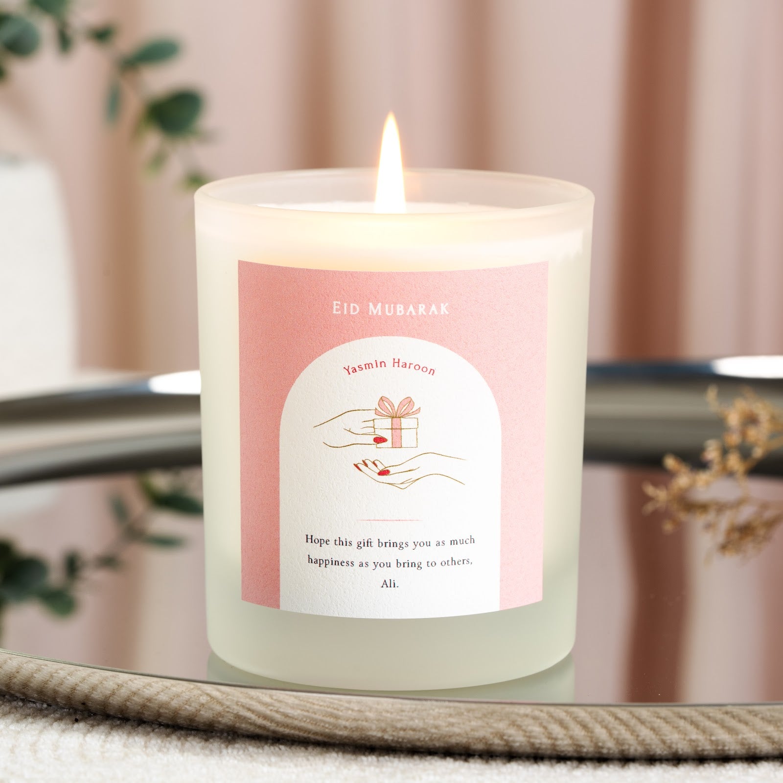 Personalised Eid Mubarak candle with a white arch on a solid pink background