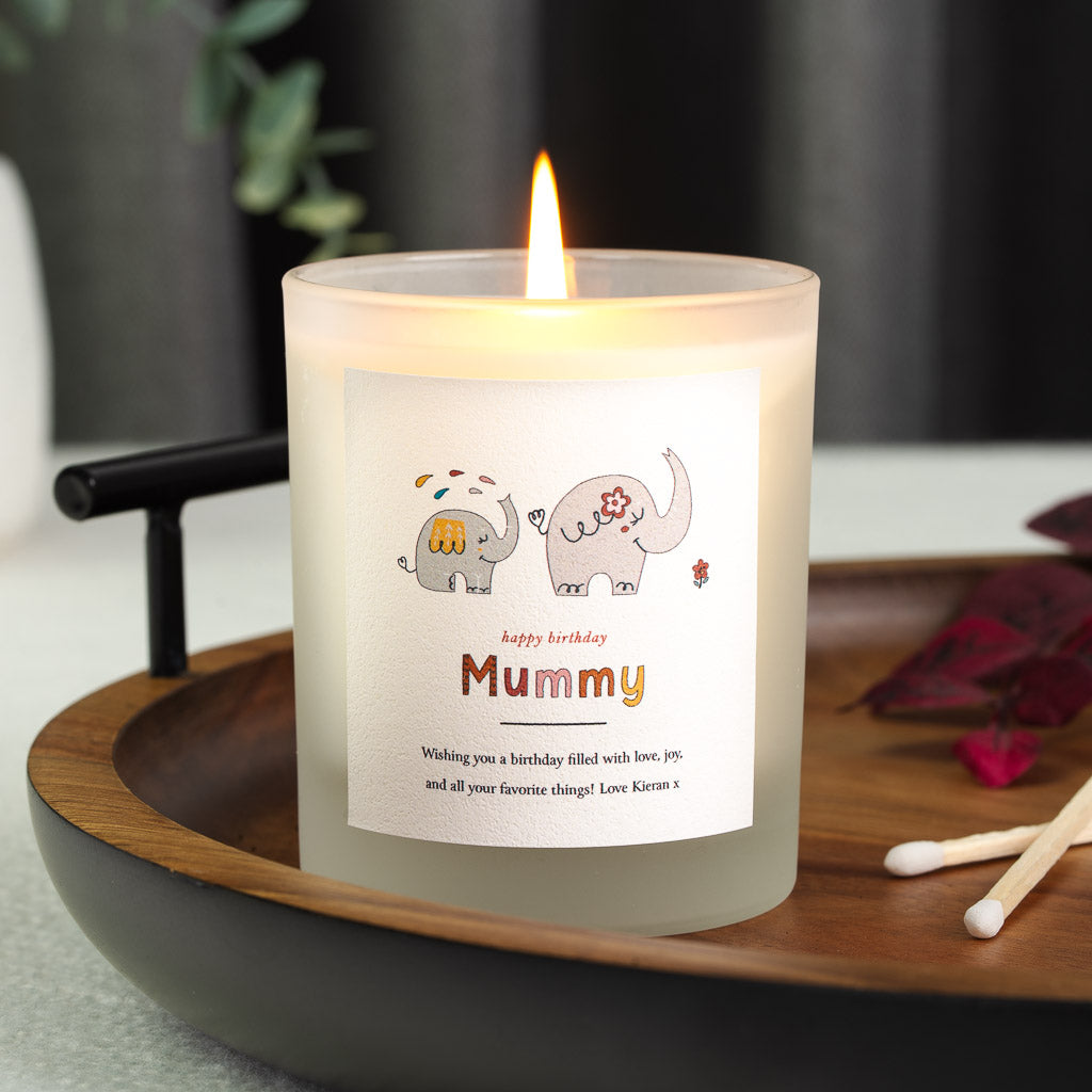 Personalised birthday candle with an elephant illustration above warm orange script