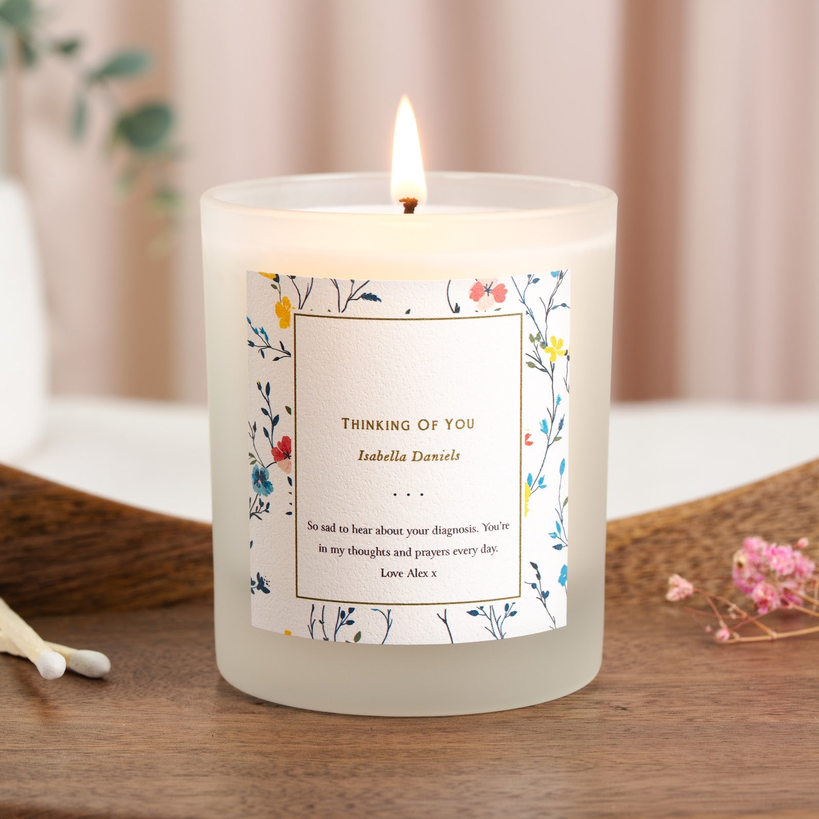 Personalised get well candle with a mixed floral border around a thin gold-toned panel