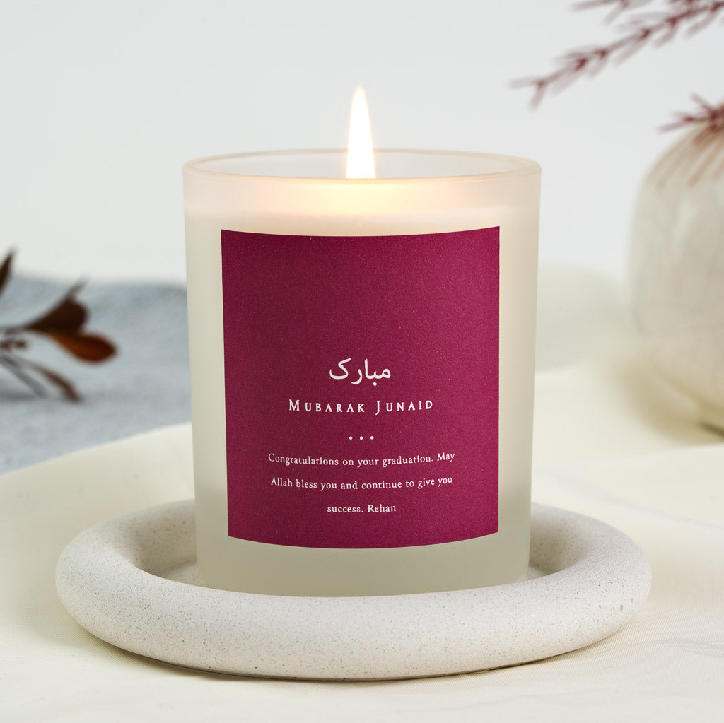 Magenta background with white Arabic script on a personalised Islamic celebration candle