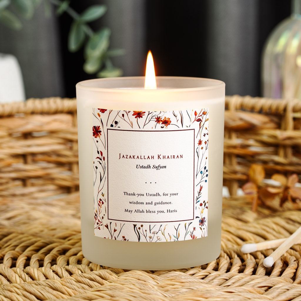 Personalised Islamic teacher candle with pressed wildflowers framing a plain white centre