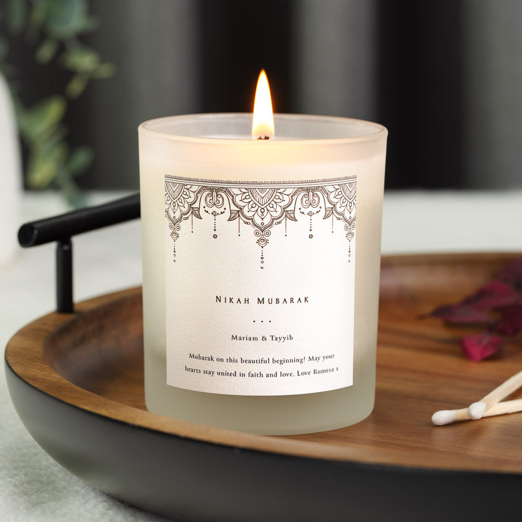 Detailed lace mandala in fine black line above a nikah mubarak heading on a personalised candle