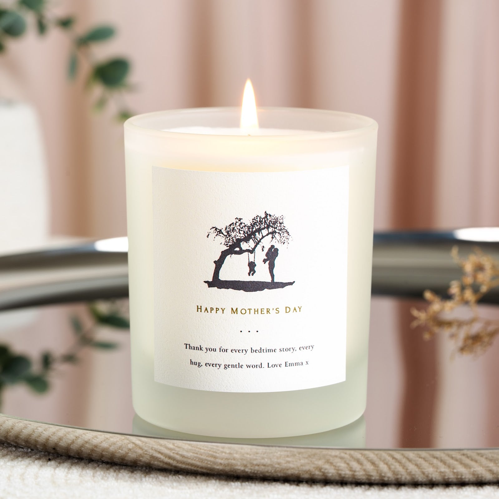 Black silhouette of a tree swing scene on a personalised Mother's Day candle label
