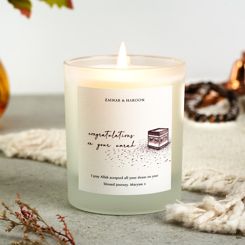 Personalised Umrah candle with the Kaaba sketched in warm burgundy ink beneath the names