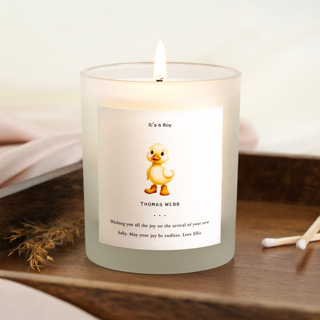 Personalised new baby candle with a duckling in boots above the baby's full name