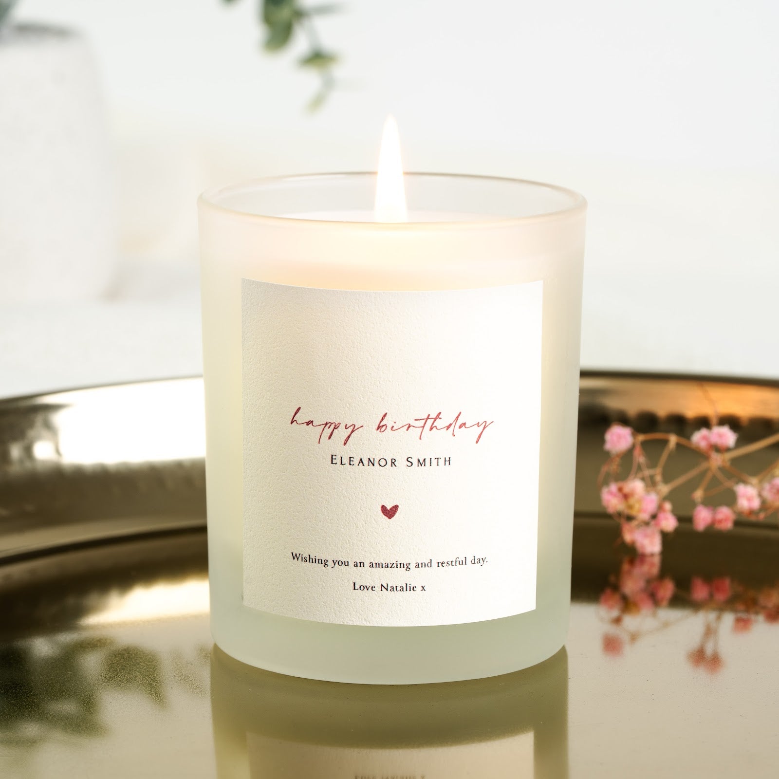 Delicate script greeting above a small heart on a personalised birthday candle label