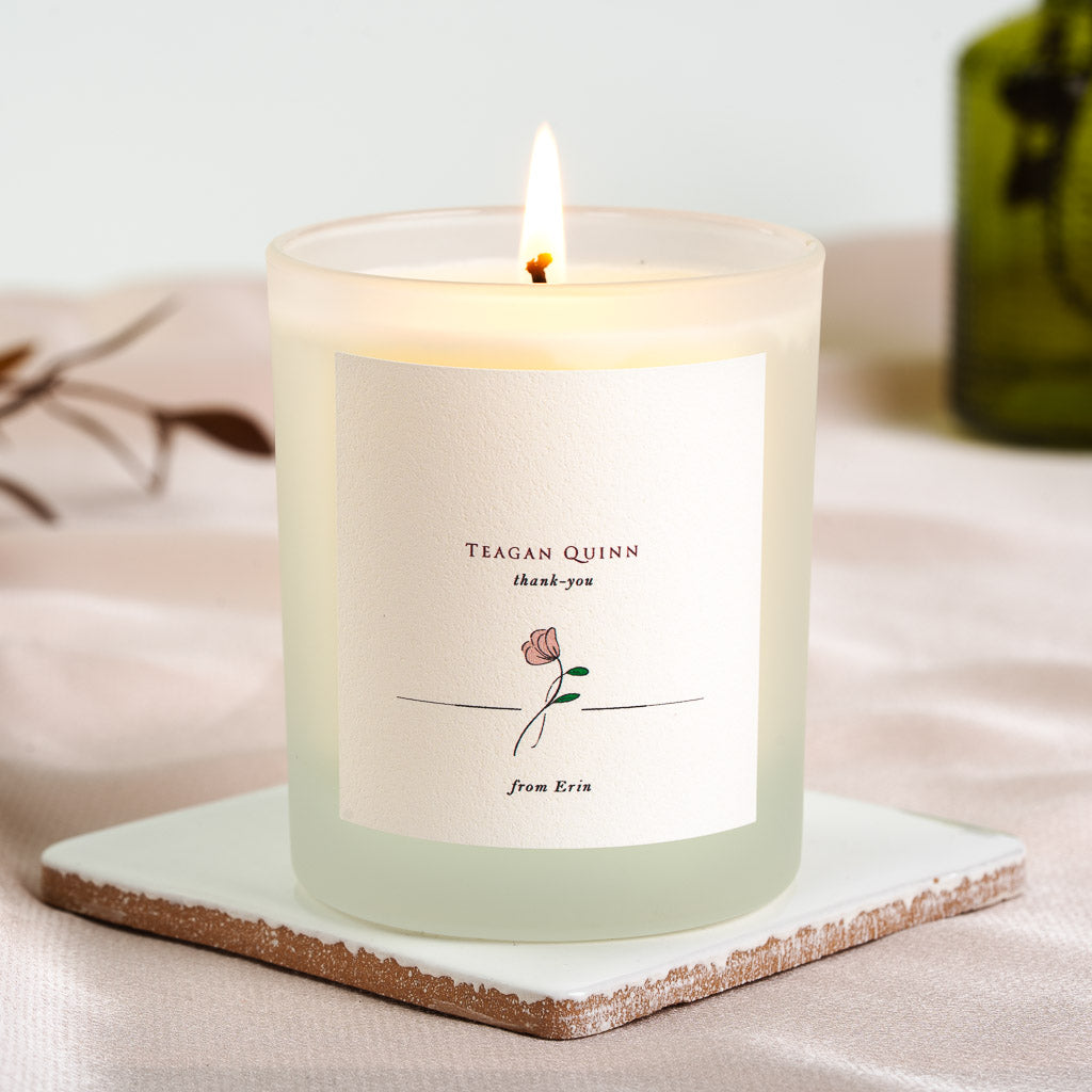 Rose illustration centred beneath a plain serif thank you on a personalised candle label