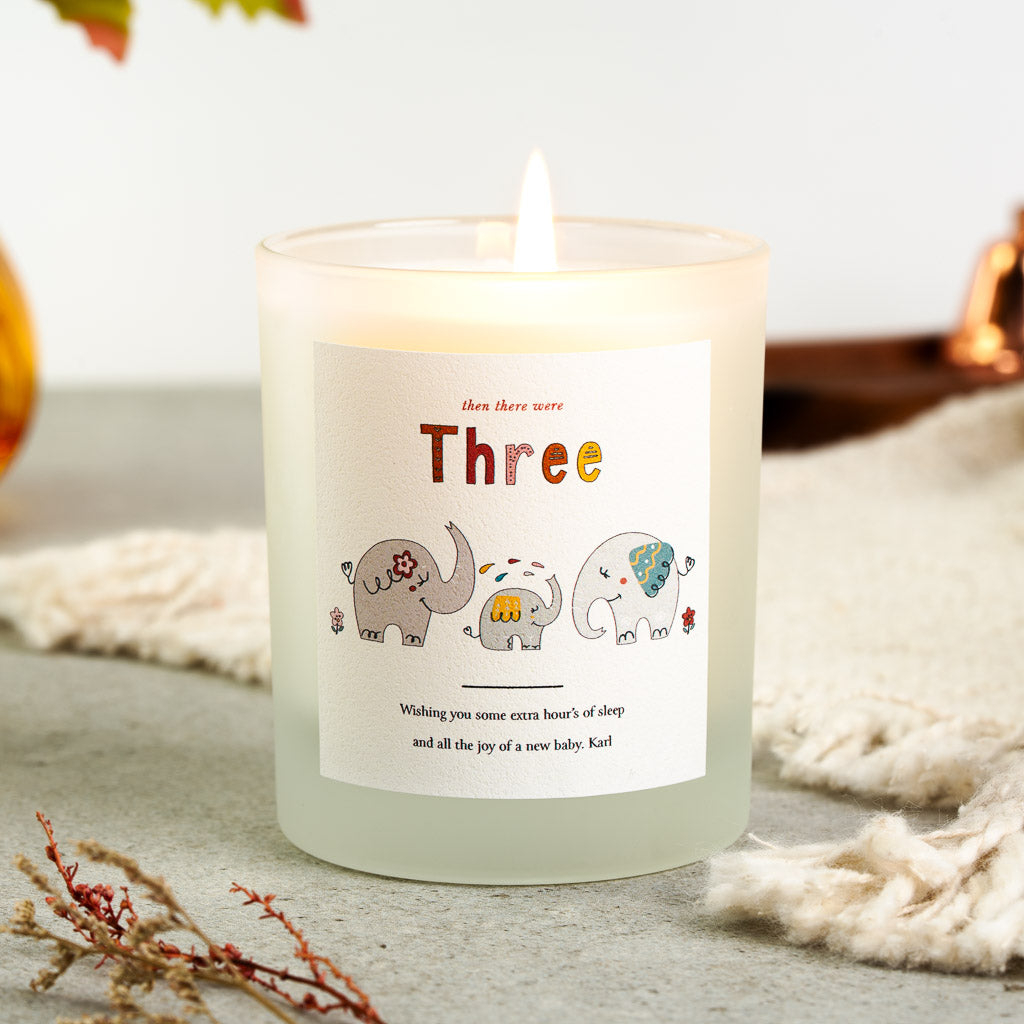 Personalised new baby candle with three hand-drawn elephants rising in size