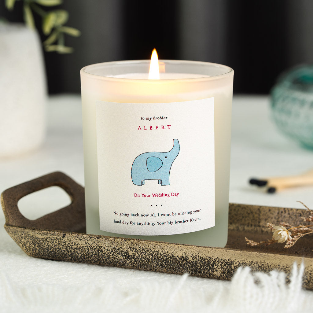 Personalised wedding candle with a blue elephant illustration and red capital lettering